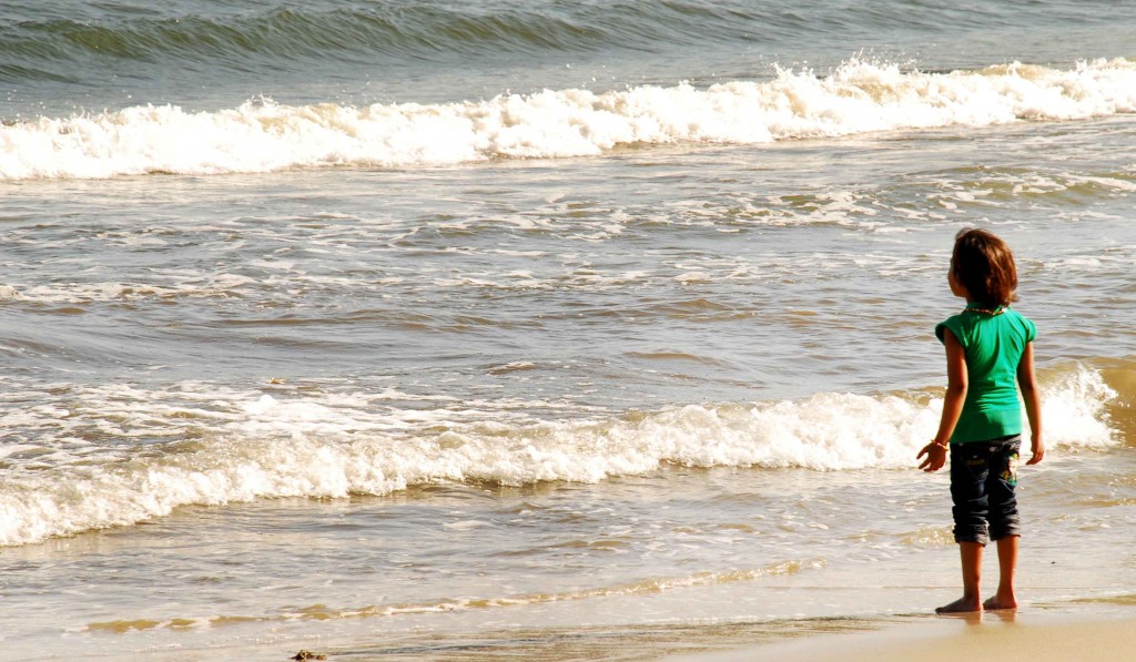 A girl awes at the oncoming waves