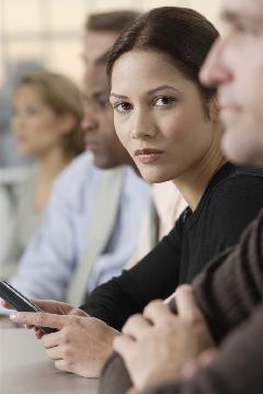 Businesswoman with Handheld Device --- Image by © Royalty-Free/Corbis