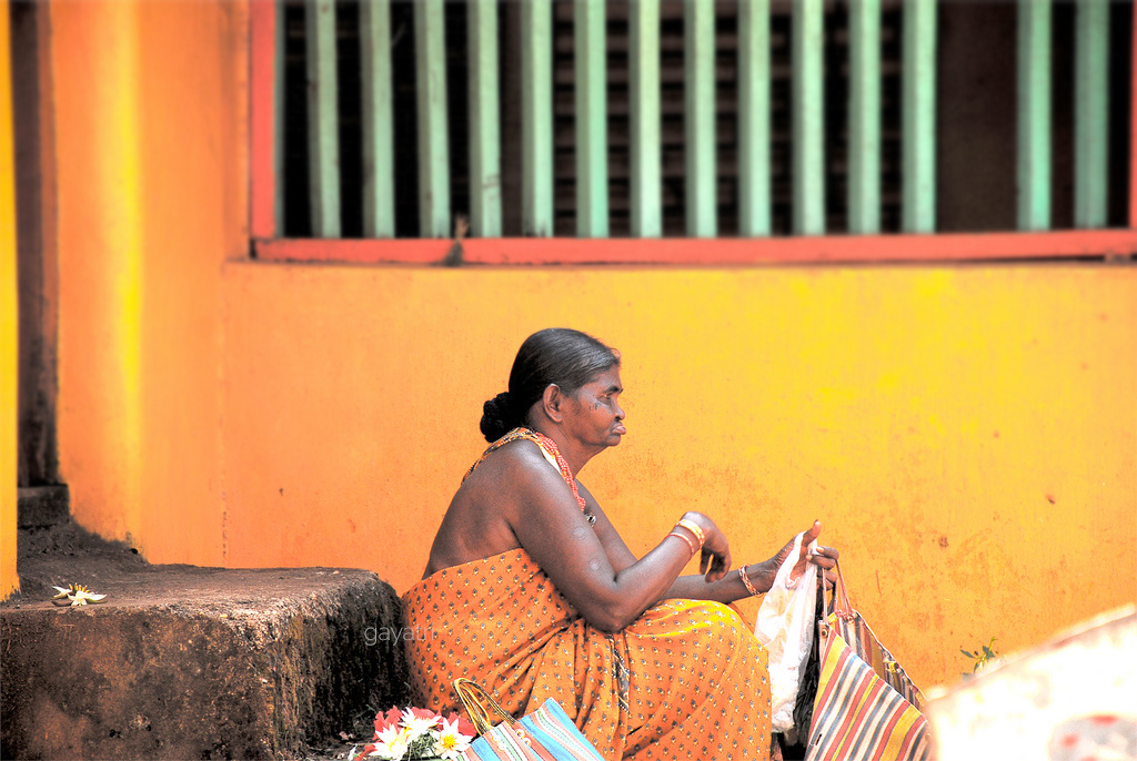 A lady takes rest at Gokarna streets after selling flowers