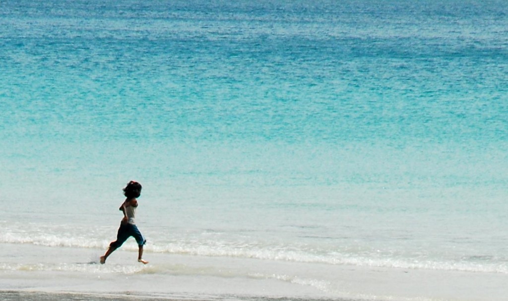 A girl runs off to the sea