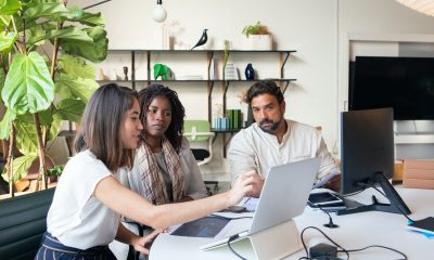 a group of people having a meeting in the office